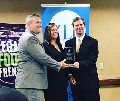 Photo of Hicks & Funfsinn attorneys receiving Solo Firm category award at the KY Legal Food Frenzy Hunger Relief Campaign in 2019