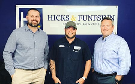 Photo of Jacob T. with the attorneys of Hicks and Funfsinn